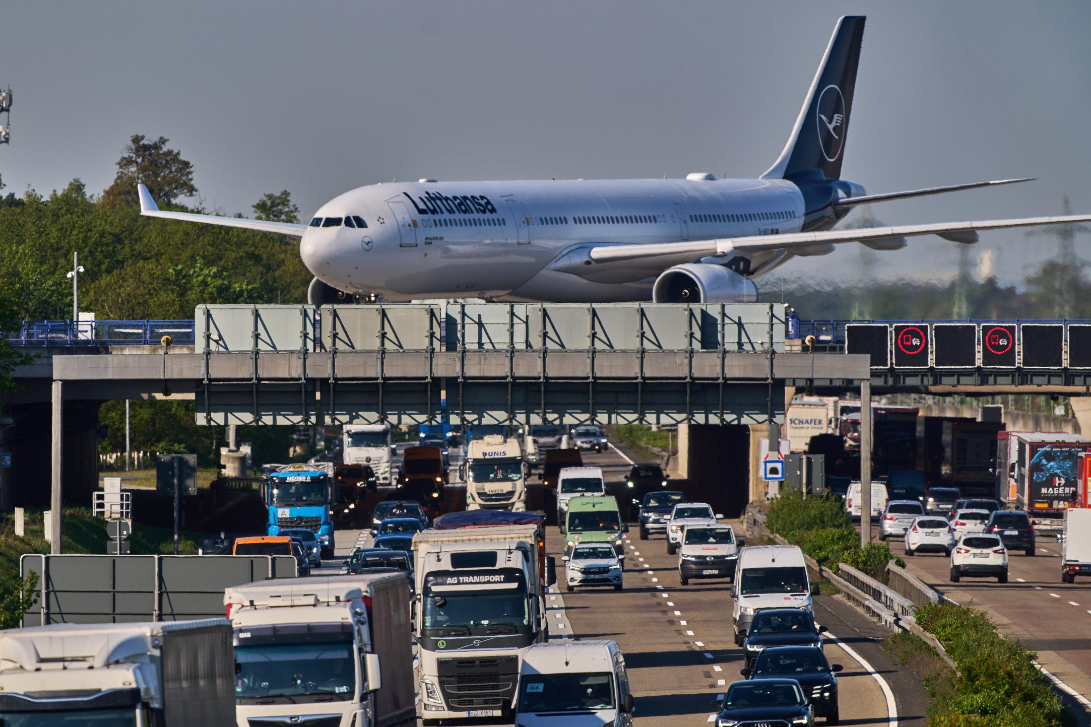 A Lufthansa aircraft rolls on a bridge over a highway at the airport in Frankfurt, Germany, Wednesday, April 22, 2026. (AP Photo/Michael Probst)