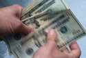 FILE- In this June 15, 2018, file photo, twenty dollar bills are counted in North Andover, Mass. (AP Photo/Elise Amendola, File)