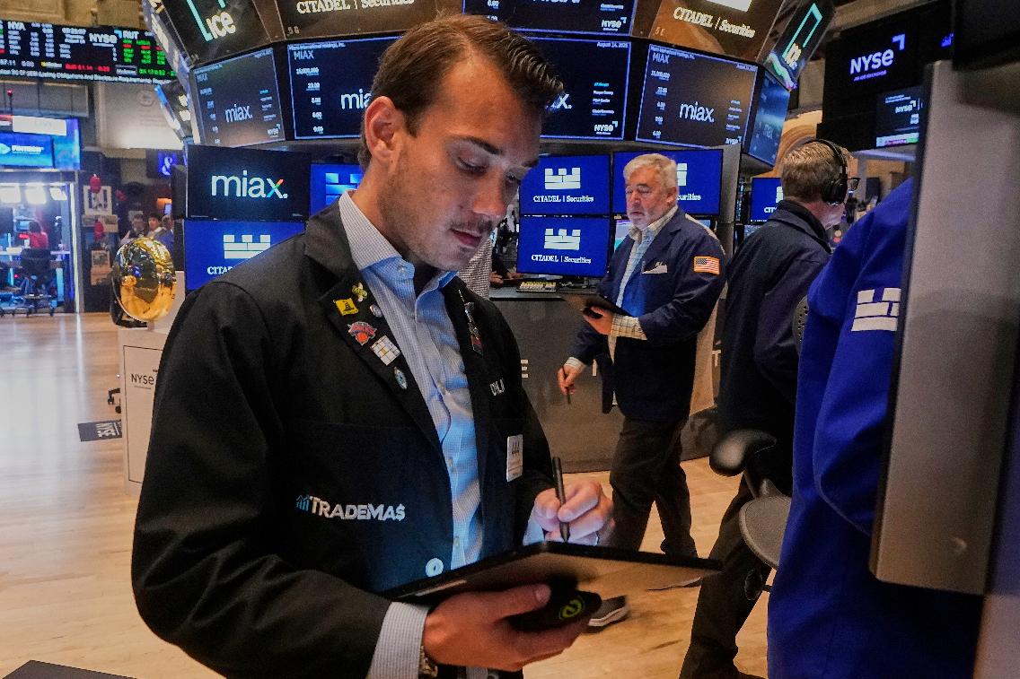 Trader Dylan Halvorsan works on the floor of the New York Stock Exchange, Thursday, Aug. 14, 2025. (AP Photo/Richard Drew)