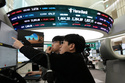 Currency traders watch monitors near a screen showing the Korea Composite Stock Price Index (KOSPI), top center, and the foreign exchange rate between U.S. dollar and South Korean won, top center left, at the foreign exchange dealing room of the Hana Bank headquarters, in Seoul, South Korea, Thursday, March 5, 2026. (AP Photo/Ahn Young-joon)