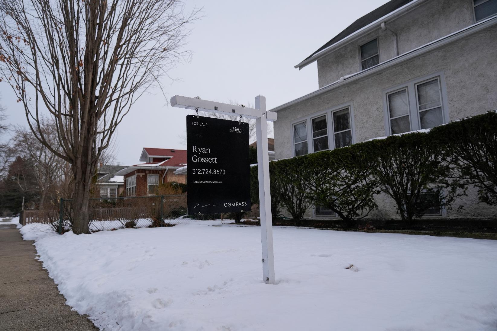 A for sale sign is posted outside a home Monday, Feb. 9, 2026, in Chicago. (AP Photo/Erin Hooley)