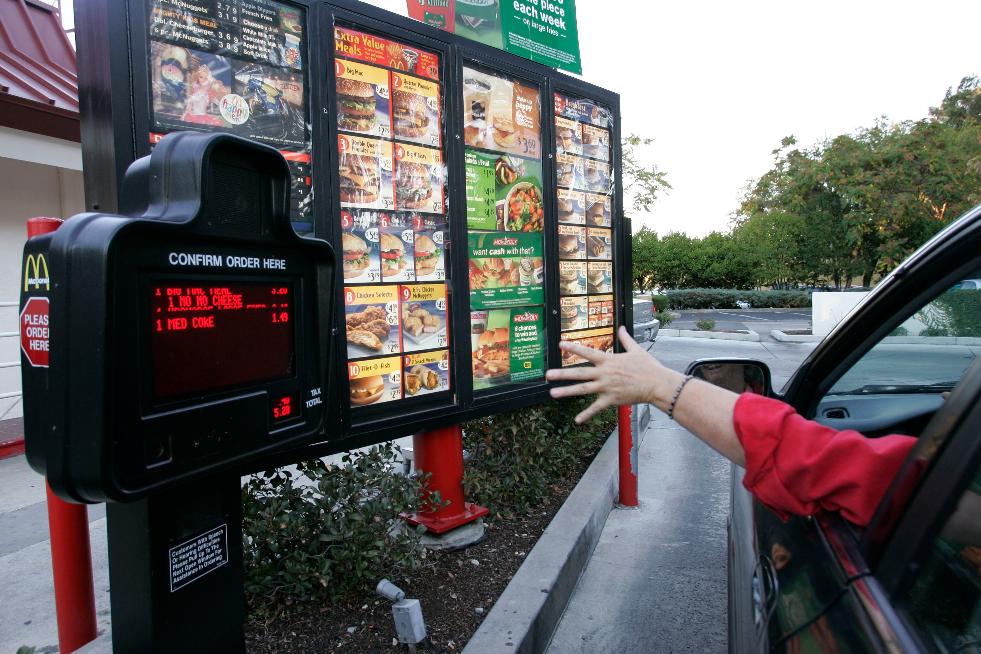 FILE - A customer orders a meal at a drive-thru at McDonald's restaurant in Palo Alto, Calif., Wednesday, Oct. 18, 2006. (AP Photo/Paul Sakuma, File)