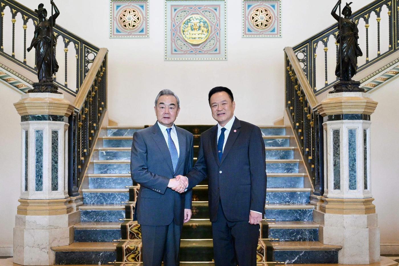 In this photo released by Thailand's Prime Minister's Office, Thai Prime Minister Anutin Charnvirakul, right, greets Chinese Foreign Minister Wang Yi during their meeting in Bangkok, Thailand, on Friday, April 24, 2026. (Thailand's Prime Minister's Office via AP)