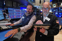Specialist Michael Pistillo. Left, and trader Fred's Demarco work on the floor of the New York Stock Exchange, Wednesday, May 13, 2026. (AP Photo/Richard Drew)