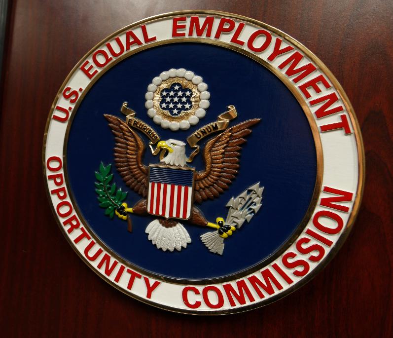 FILE - The emblem of the U.S. Equal Employment Opportunity Commission (EEOC) is displayed on a podium in Denver on Feb. 16, 2016. (AP Photo/David Zalubowski, File)