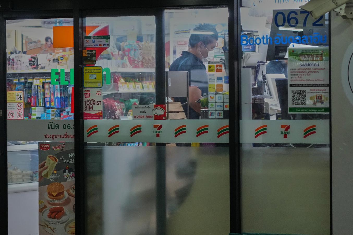 A Thai customer lines up to pay money at a convenience store in Bangkok, Thailand, Wednesday, Dec. 3, 2025. (AP Photo/Sakchai Lalit)