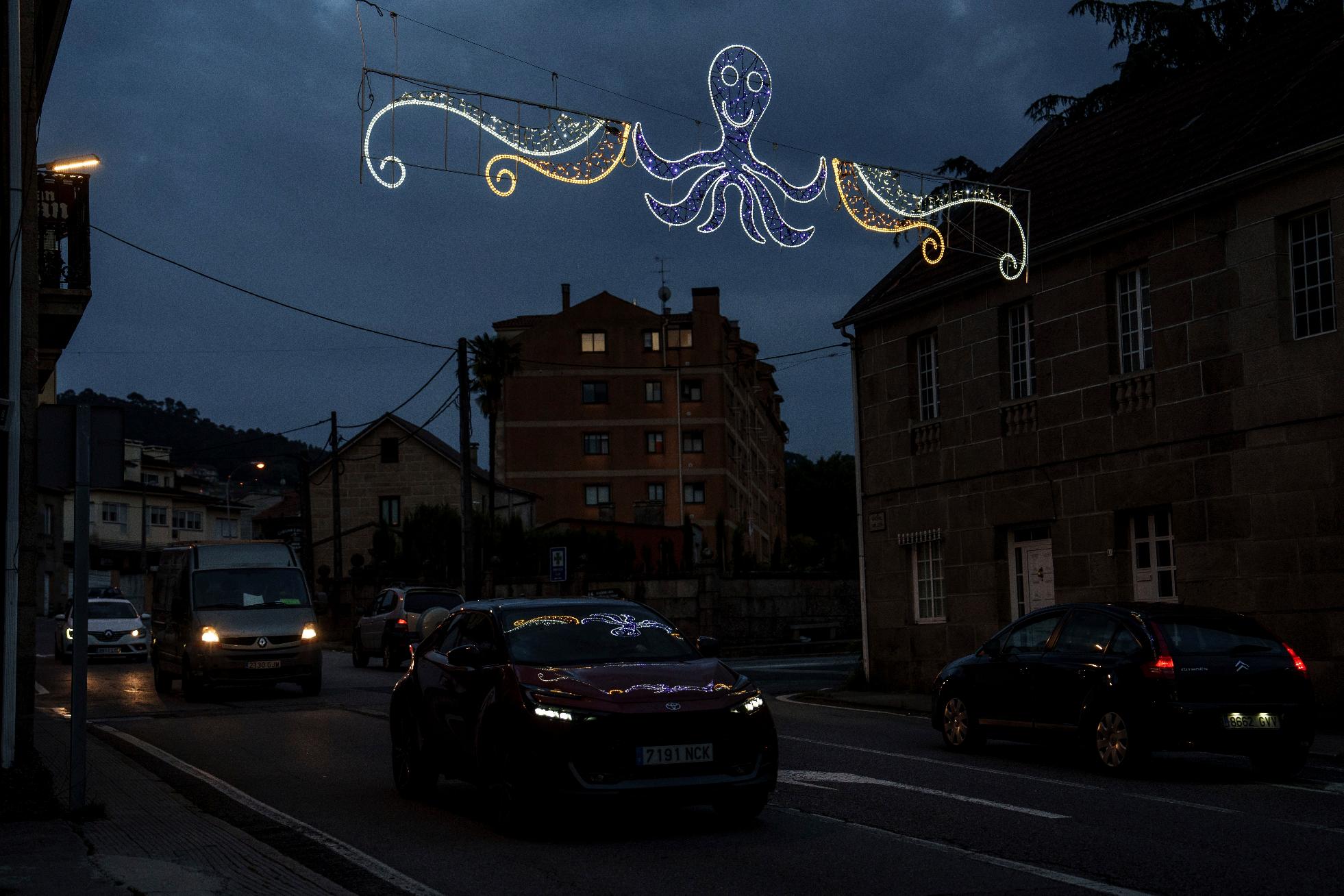 Lights with likeness of an octopus is illuminated over a street Tuesday, June 24, 2025, in Pontevedra, Spain. (AP Photo/Annika Hammerschlag)