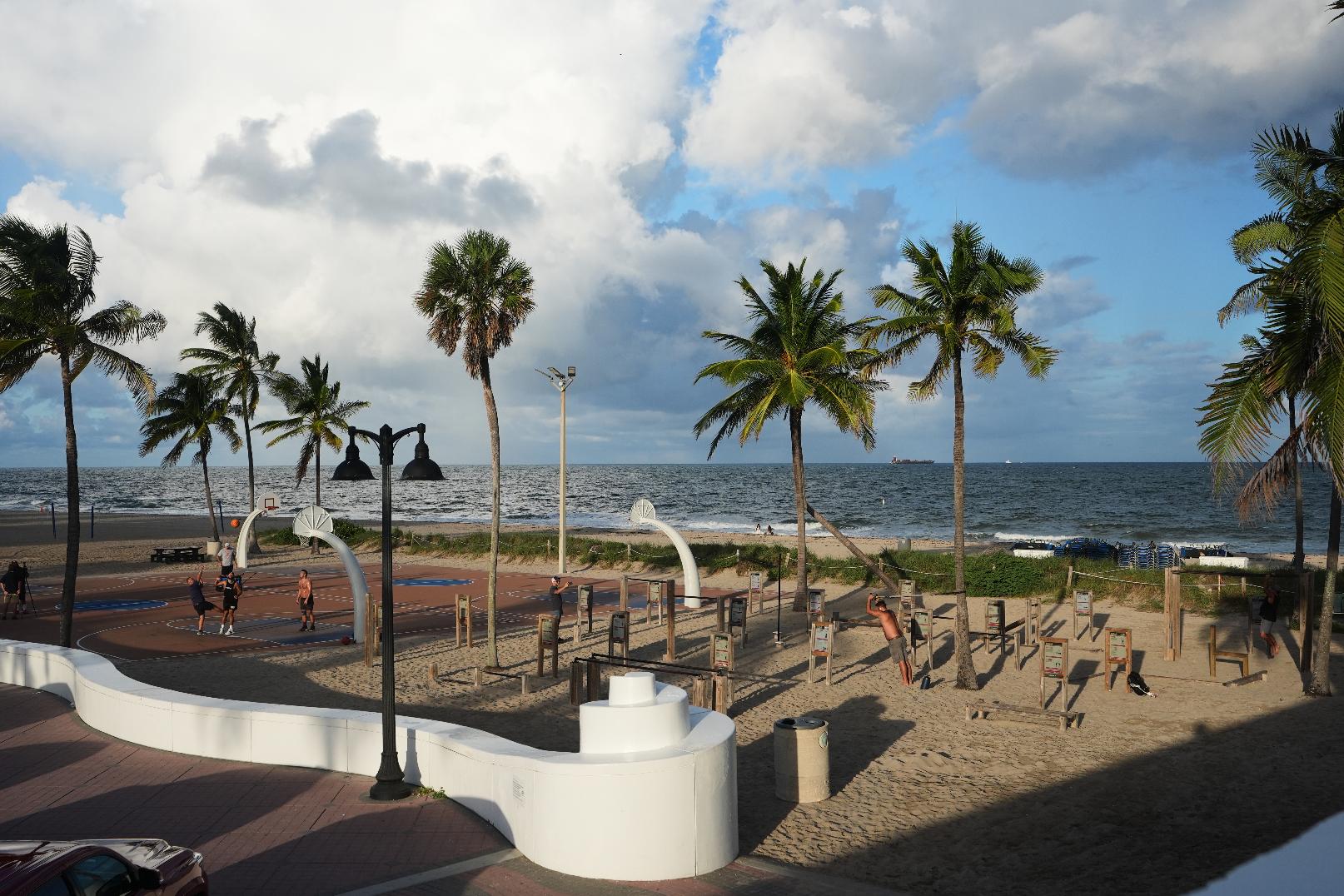 People play basketball and use gym equipment at the Fort Lauderdale Beach Park, the site of proposed pickleball courts as part of a new luxury development, Oct. 8, 2025, in Fort Lauderdale, Fla. (AP Photo/Lynne Sladky)
