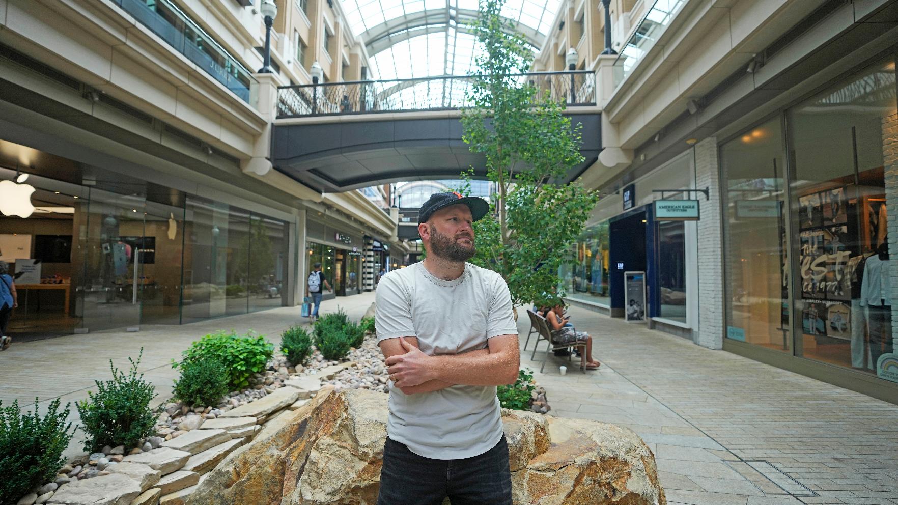 Jake Welch stands in open-air shopping center, Wednesday, Aug. 2, 2023, in Salt Lake City. The 36-year-old brand director for an advertising firm calculates the cost-per-wear of his wardrobe by highlighting 200 items in a spreadsheet — excluding underwear and socks — and meticulously listing the price he paid for each of them as well as how many times he's worn it. (AP Photo/Rick Bowmer)
