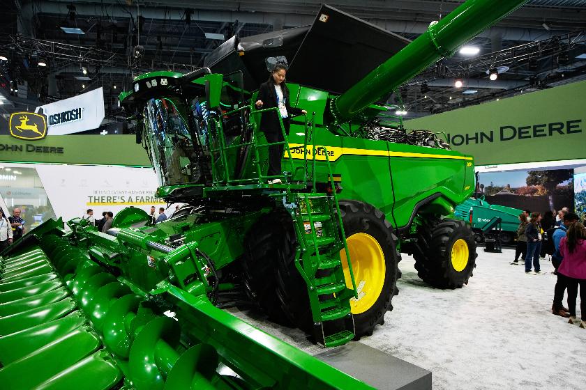 FILE - A person walks on an X9 1100 combine at the John Deere booth during the CES tech show, Jan. 6, 2026, in Las Vegas. (AP Photo/John Locher, File)