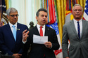 Dr. Marty Makary, commissioner of the Food and Drug Administration, center, speaks while National Institutes of Health Director Dr. Jay Bhattacharya, left, and Health and Human Services Secretary Robert F. Kennedy Jr., right, listen in the Oval Office of the White House, Saturday, April 18, 2026, in Washington. (AP Photo/Julia Demaree Nikhinson)