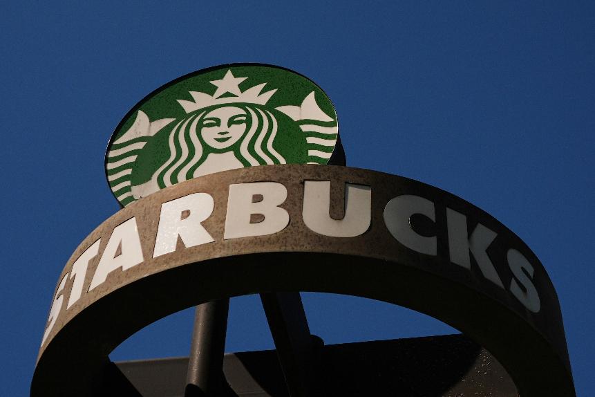 FILE - A Starbucks sign is seen outside the coffee company's global corporate headquarters, May 11, 2026, in Seattle. (AP Photo/Lindsey Wasson, File)