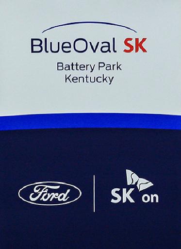 FILE - Logos for BlueOval SK and Ford are displayed on a podium during a celebration for the progress of the BlueOval SK Battery Park in Glendale, Ky., Dec. 5, 2022. (Gina Clear/The News-Enterprise via AP)