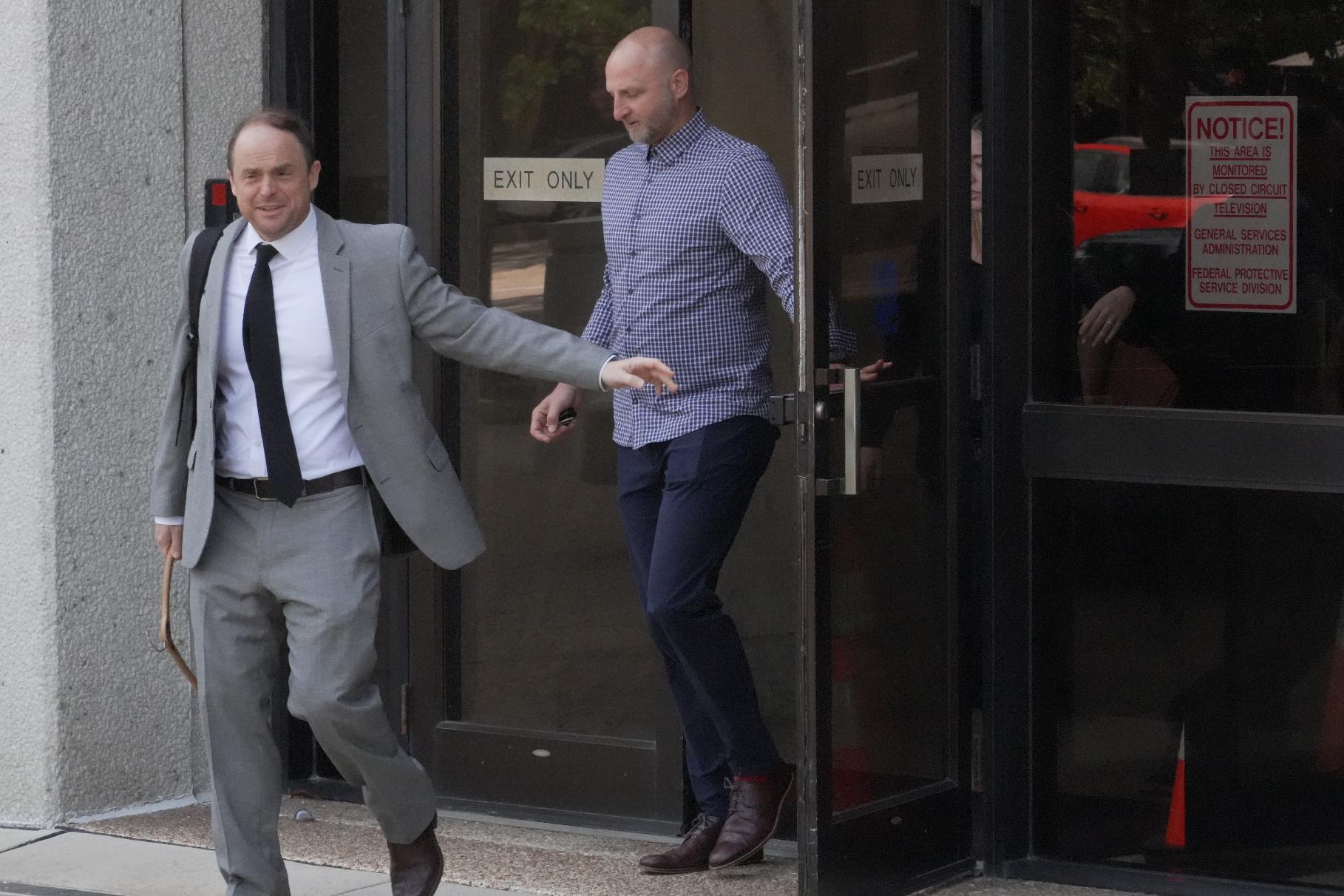 Assistant U.S. Attorney Logan Liles, left, leaves the federal courthouse in Raleigh, N.C., on Friday, April 24, 2026, during the case of Gannon Ken Van Dyke, a soldier who is charged with using his access to classified information about the operation to capture Venezuelan President Nicolas Maduro in January to win money on Polymarket. (AP Photo/Allen G. Breed)