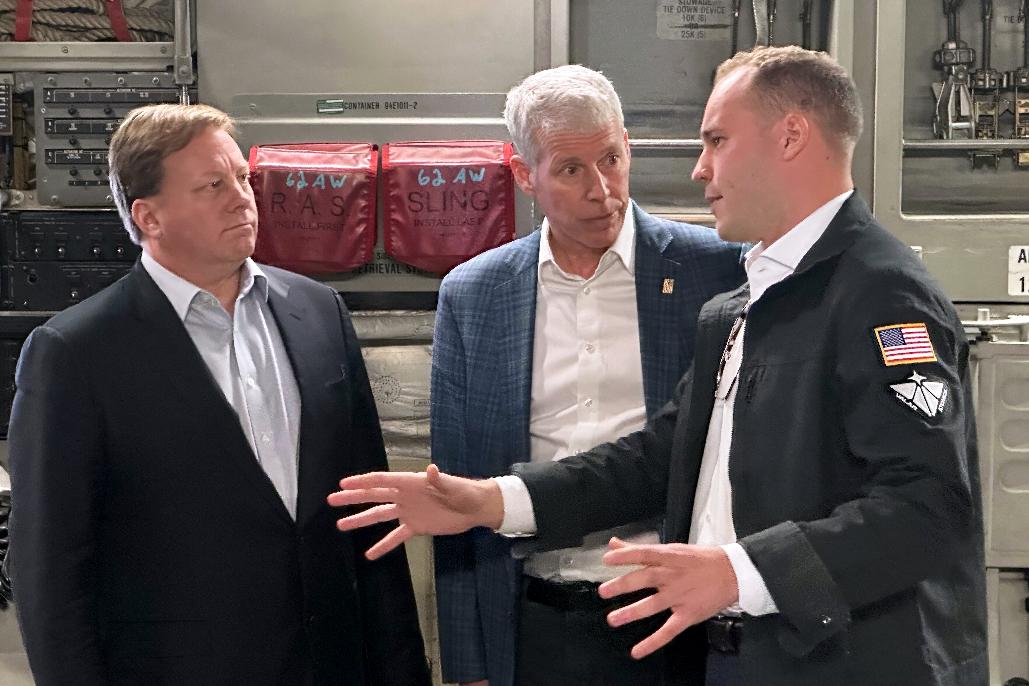 FILE - Energy Secretary Chris Wright, center, and Under Secretary of Defense Michael Duffey, left, listen as Isaiah Taylor, CEO of Valar Atomics, discusses a microreactor developed by Valar to generate nuclear power for the military and commercial customers, Feb. 15, 2026, in-flight, on board a C-17. (AP Photo/Matthew Daly, File)