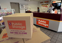 FILE - Carol Avalos, far left, Wes Demory, center, and Desiree Mora working at the customer service desk for Public Storage, Inc. on March 7, 2006, in the Eagle Rock section of Los Angeles. (AP Photo/Ric Francis, File)