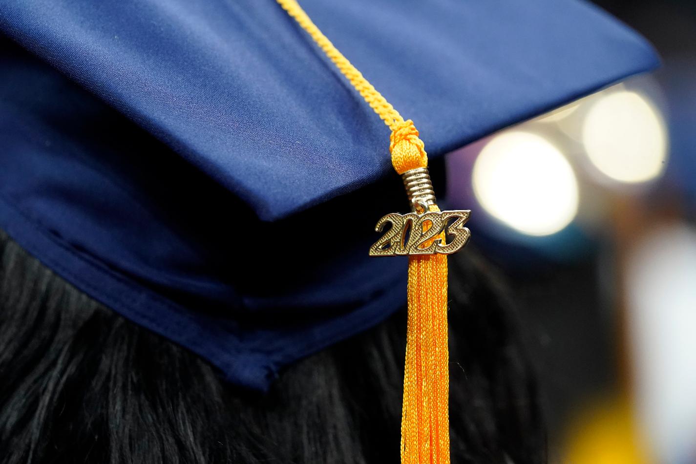 FILE - A tassel with 2023 on it rests on a graduation cap as students walk in a procession for Howard University's commencement in Washington, Saturday, May 13, 2023. MBA grads say the investment in their degree was worth it, according to a 2022 survey by the Graduate Management Admission Council, an association of graduate business schools. (AP Photo/Alex Brandon, File)