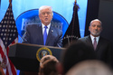 President Donald Trump speaks during a press briefing at the White House, Friday, Feb. 20, 2026, in Washington, as Commerce Secretary Howard Lutnik, looks on. (AP Photo/Evan Vucci)