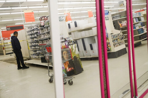 People shop the half-empty shelves of the Kmart in Avenel, N.J., Monday, April 4, 2022. When the Kmart in Avenel closes its doors on April 16, it will leave only three remaining U.S. locations for the former retail powerhouse. It's a far cry from the chain's heyday in the 1980s and ‘90s when it had more than 2,000 stores and sold product lines endorsed by Martha Stewart and former “Charlie's Angel” Jaclyn Smith. (AP Photo/Seth Wenig)