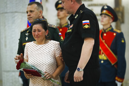 FILE - Alima Tatiyeva, widow of Nurlan Tatiyev, Russian soldier who was killed in battles in Ukraine cries during a ceremony of handing over the Orders of Courage to families of killed soldiers in Volgograd, Russia, Thursday, June 30, 2022. (AP Photo, File)