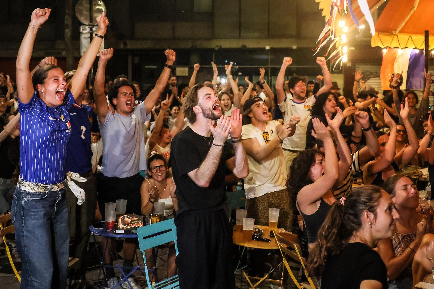 French fans react after France defeated Morocco during their World Cup quarterfinal soccer match, Friday July 10, 2026, in Paris. (AP Photo/Thomas Padilla)