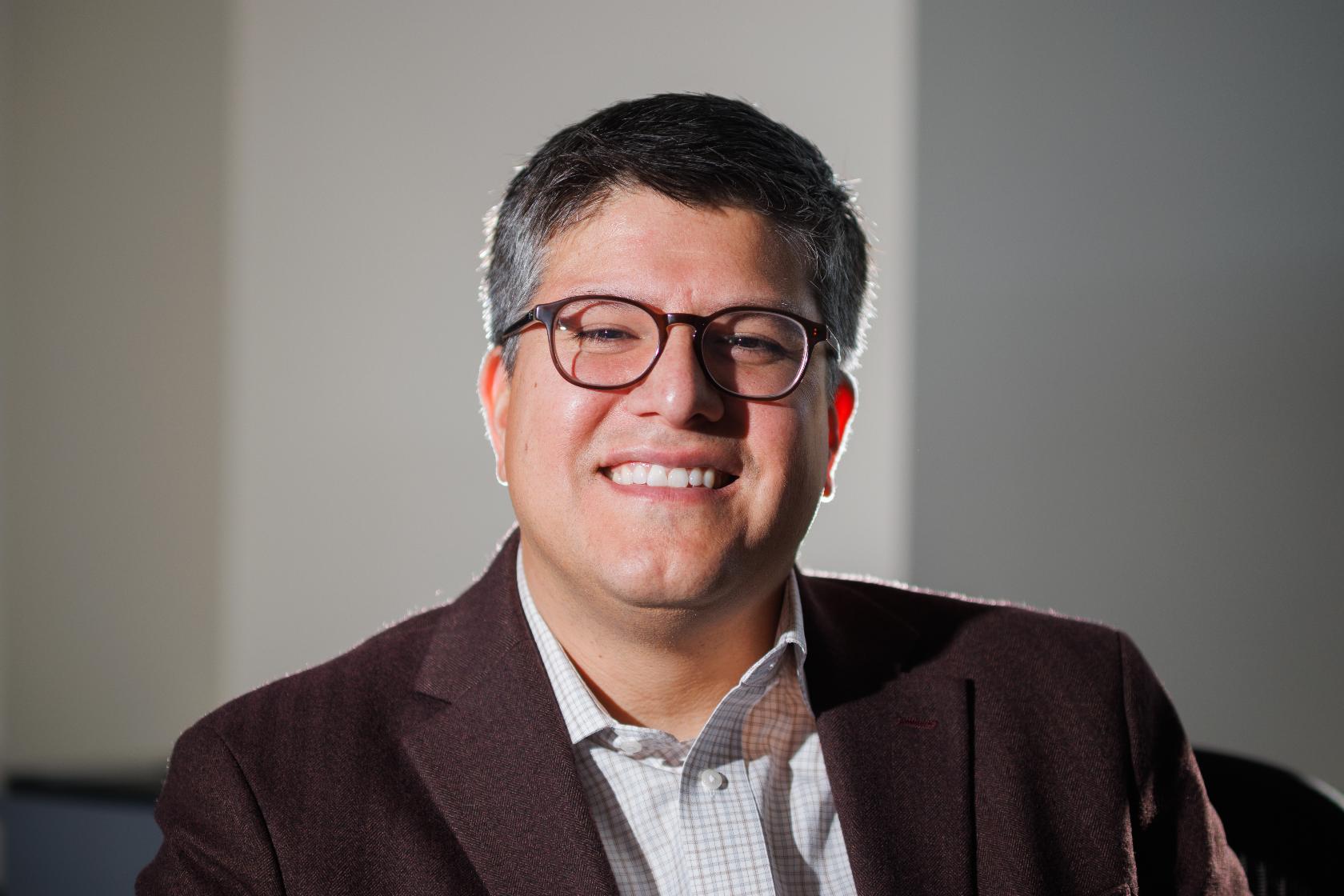 Juan Espinoza, vice provost for enrollment management at Virginia Tech, poses for a photo in his office, Nov. 12, 2025, in Blacksburg, Va. (AP Photo/Shaban Athuman)