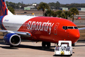 FILE - A Sun Country Airlines jet is pushed back from a gate at Sarasota-Bradenton International Airport in Sarasota, Fla., Friday, Feb. 13, 2026. (AP Photo/Gene J. Puskar,File)