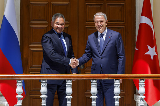 In this handout photo released by Russian Defense Ministry Press Service, Russian Defense Minister Sergei Shoigu, left, and Turkish Defense Minister Hulusi Akar pose for a photo during their meeting in Istanbul, Turkey, Friday, July 22, 2022. U.N. Secretary General Antonio Guterres and Turkish President Recep Tayyip Erdogan were due on Friday to oversee the signing of a key agreement that would allow Ukraine to resume its shipment of grain from the Black Sea to world markets and for Russia to export grain and fertilizers, ending a standoff that has threatened world food security. (Vadim Savitsky, Russian Defense Ministry Press Service via AP)
