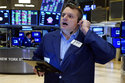 Trader Michael Milano works on the floor of the New York Stock Exchange, Monday, Nov. 29, 2021. Stock indexes are edging higher on Wall Street Monday as markets regain their footing following a big stumble on Friday on worries about the spread of the new variant of the coronavirus. (AP Photo/Richard Drew)