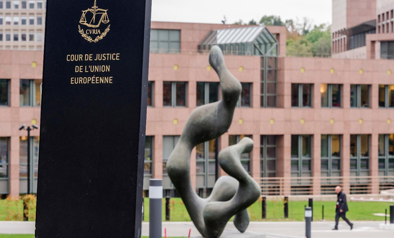 FILE - A man walks by the European Court of Justice in Luxembourg, Oct. 5, 2015. (AP Photo/Geert Vanden Wijngaert, File)