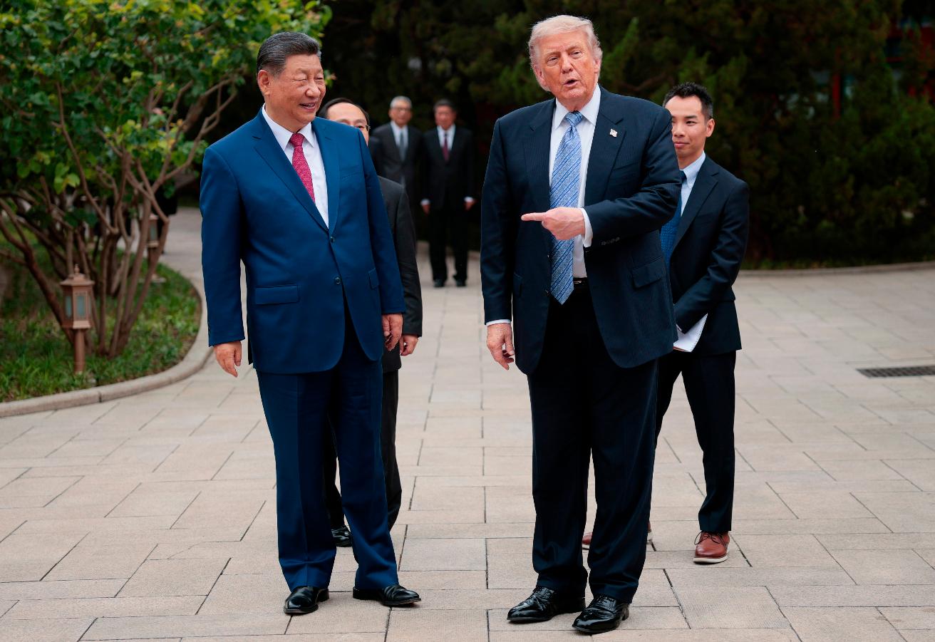 U.S. President Donald Trump gestures towards Chinese President Xi Jinping while leaving after a visit to the Zhongnanhai Garden in Beijing, Friday, May 15, 2026. (Evan Vucci/Pool Photo via AP)