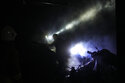 Ukrainian firefighters work among debris following a Russian shelling in Kharkiv, Ukraine, early Saturday, Oct. 8, 2022. A series of explosions have rocked the eastern Ukraine city of Kharkiv, sending towering plumes of illuminated smoke in the sky and triggering a series of secondary explosions. (AP Photo/Francisco Seco)