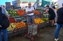 A customer waits to be attended at a greengrocer's stall in Buenos Aires, Argentina, Tuesday, Feb. 10, 2026. (AP Photo/Rodrigo Abd)