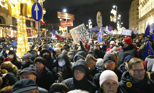 FILE - People demonstrate after the Polish parliament approved a bill that is widely viewed as an attack on media freedom, in Warsaw, Poland, Sunday Dec. 19, 2021. Poland’s president on Monday, Dec. 27, 2021 says he has decided to veto a media bill that would have forced U.S. company Discovery to give up controlling share in TVN, a Polish TV network. President Andrzej Duda noted that the bill was unpopular with many Poles and would have dealt a blow to Poland's reputation as a place to do business.  (AP Photo/Czarek Sokolowski, File)
