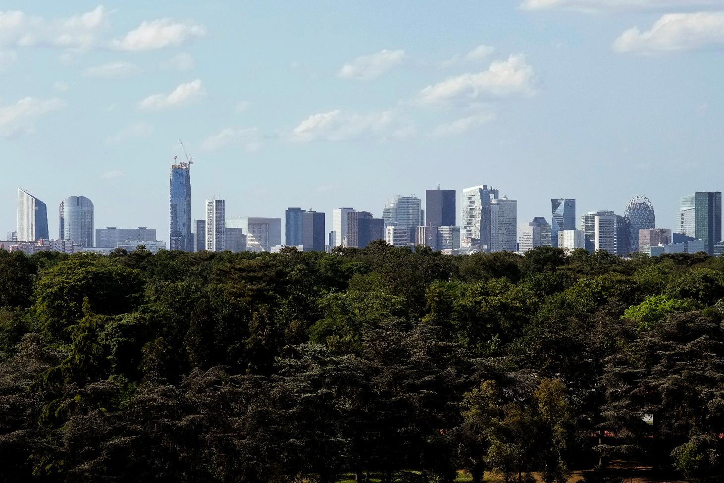 FILE - The business district of La Defense is pictured Tuesday, May 17, 2022 in Paris. French authorities raided the Paris offices of five top French banks Tuesday March 28, 2023 on suspicion of tax fraud, France's National Financial Prosecutor's Office said. The raids come as part of five preliminary investigations opened in December 2021 on counts of alleged money laundering, and alleged tax fraud linked to dividend payments, the office said in a statement (AP Photo/Christophe Ena, File)
