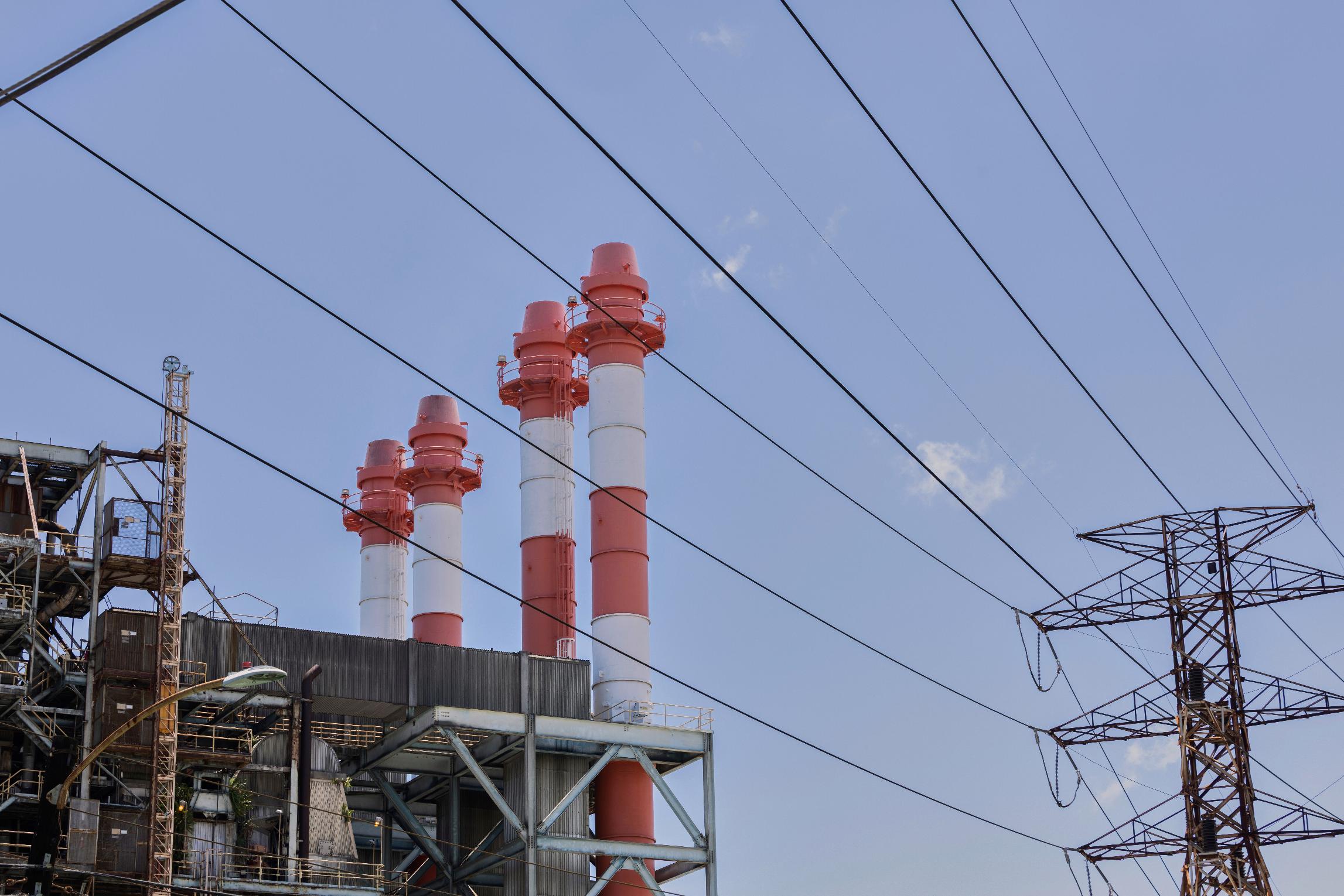 Power lines rise in front of electric towers and smokestacks at the Palo Seco power plant in Toa Baja, Puerto Rico, Thursday, May 8, 2025. (AP Photo/Alejandro Granadillo)