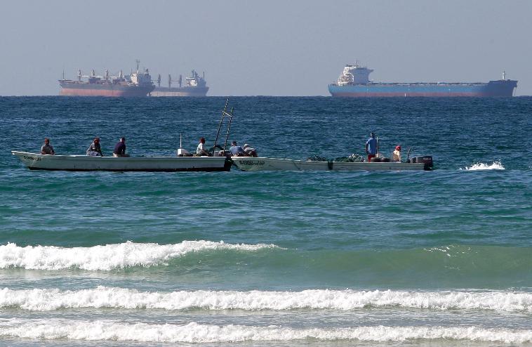 FILE - Fishermen work in front of oil tankers south of the Strait of Hormuz Jan. 19, 2012, offshore the town of Ras Al Khaimah in United Arab Emirates. (AP Photo/Kamran Jebreili, File)