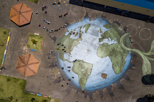 Voters arrive to a polling station at the Ceu Butanta school to vote in a presidential run-off election, in Sao Paulo, Brazil, Sunday, Oct. 30, 2022. On Sunday, voters had to choose between incumbent President Jair Bolsonaro and his rival, former President Luiz Inacio Lula da Silva, after neither got enough support to win outright in the Oct. 2 general election. (AP Photo/Matias Delacroix)