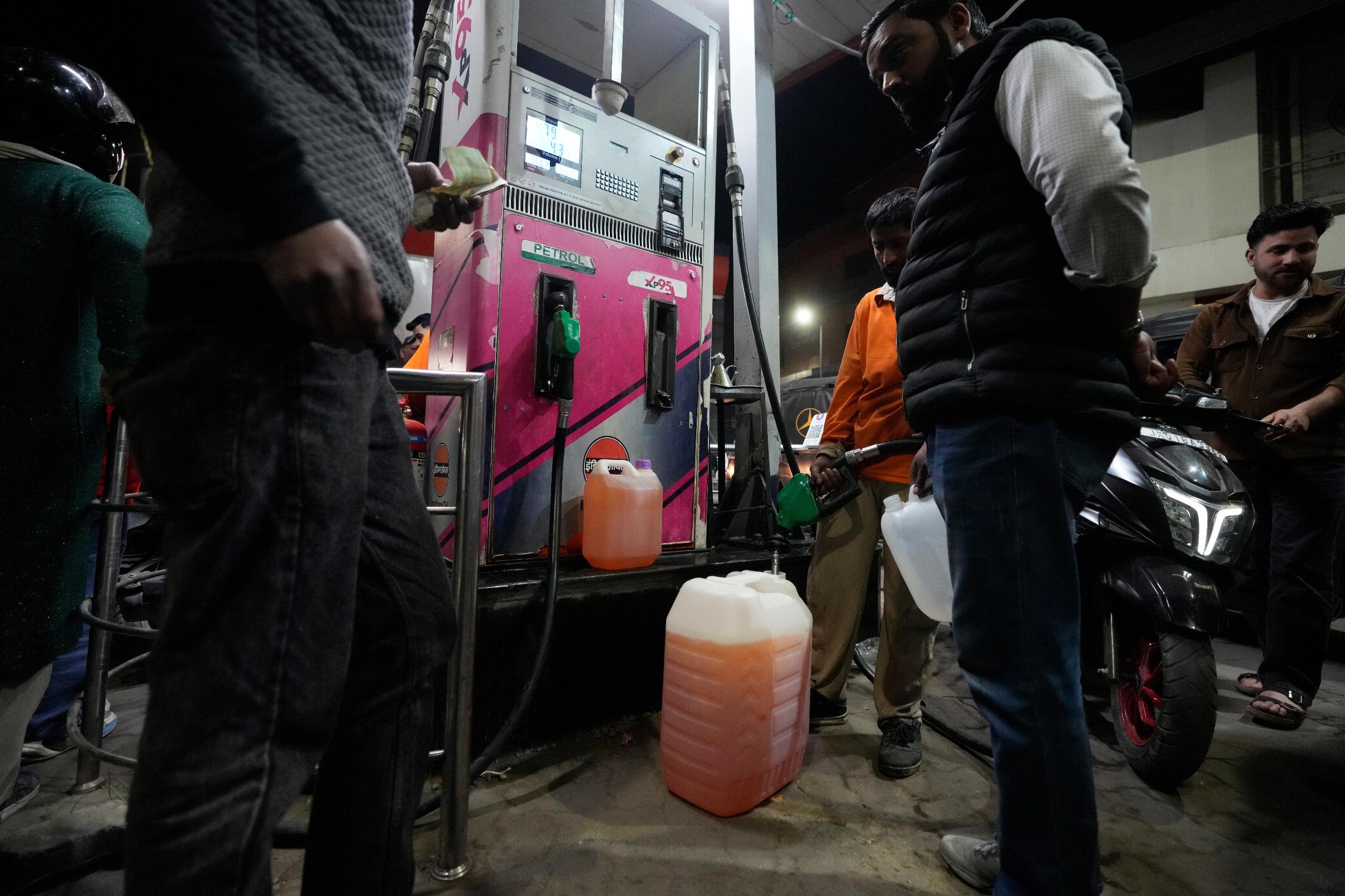 FILE - People store fuel in a plastic can at a petrol pump in Srinagar, Indian controlled Kashmir, March 25, 2026. (AP Photo/Mukhtar Khan, file)