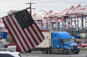 A U.S. flag files at the Port of Long Beach Friday, Feb. 20, 2026, in Long Beach, Calif. (AP Photo/Damian Dovarganes)