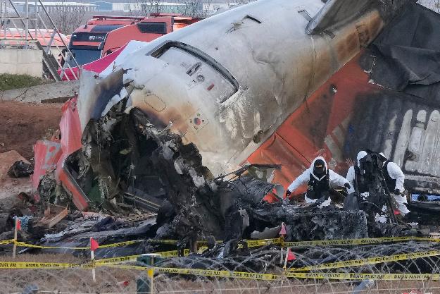 Rescue team members work at the site of a plane crash at Muan International Airport in Muan, South Korea, Tuesday, Dec. 31, 2024. (AP Photo/Ahn Young-joon)