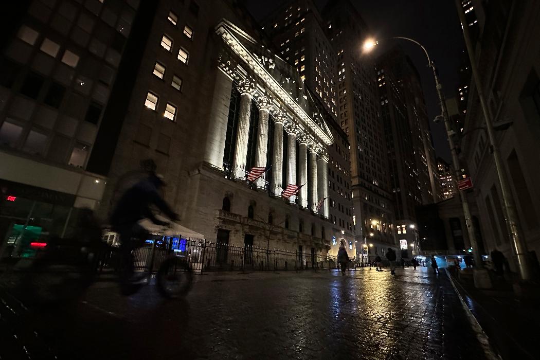 A bike approaches the New York Stock Exchange on Tuesday, Nov. 21, 2023 in New York. World shares were mixed on Wednesday in cautious trading after Wall Street's rally ran out of momentum. (AP Photo/Peter Morgan)