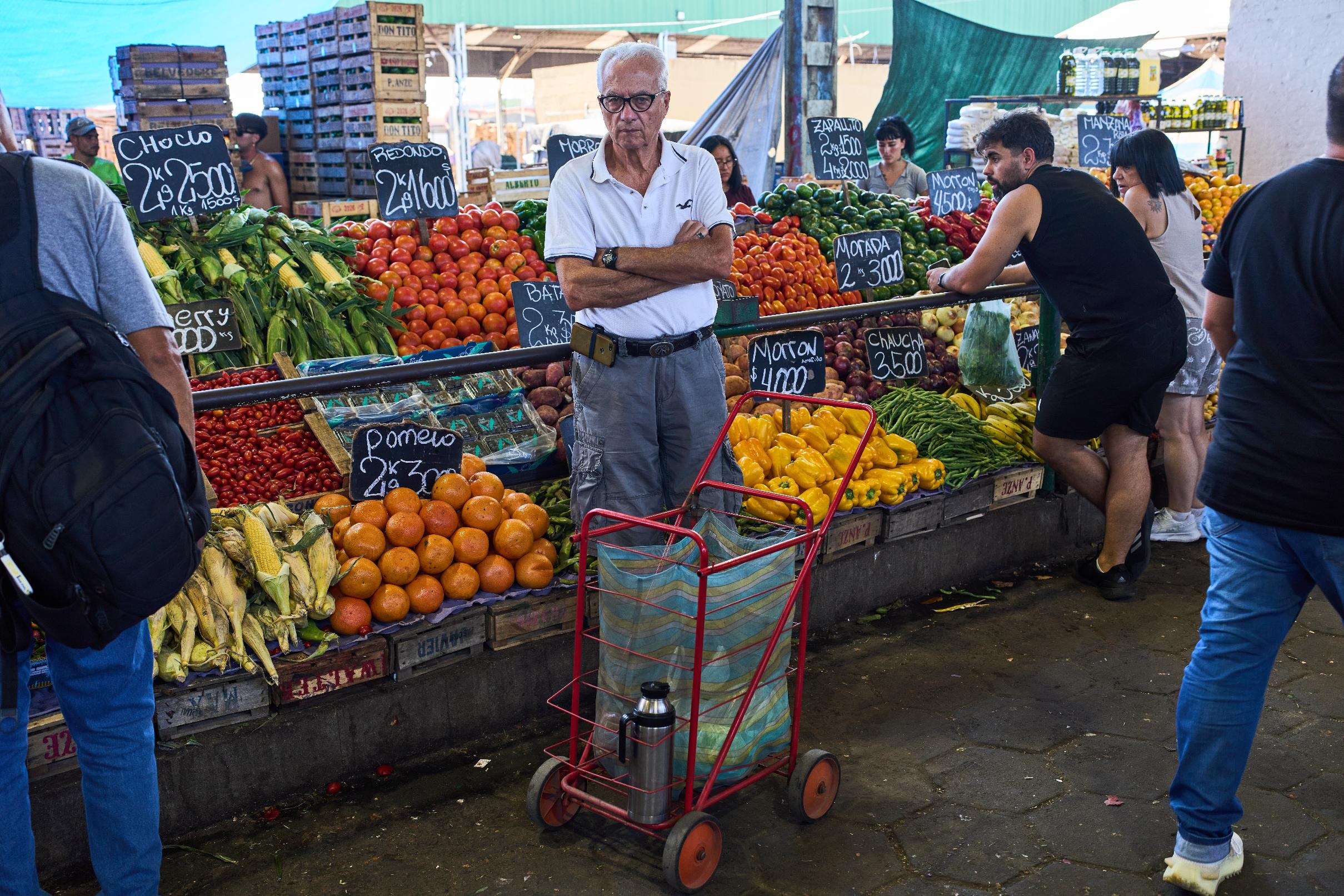 A customer waits to be attended at a greengrocer's stall in Buenos Aires, Argentina, Tuesday, Feb. 10, 2026. (AP Photo/Rodrigo Abd)