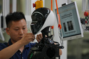 Workers assemble robot at the LY iTech Beijing Super Factory for Embodied Artificial Intelligence during a media tour in the Beijing E-Town on the outskirts of Beijing on May 29, 2026. (AP Photo/Andy Wong)