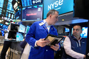 Christopher Lagana, left, and Dilip Patel work on the floor at the New York Stock Exchange in New York, Monday, March 30, 2026. (AP Photo/Seth Wenig)