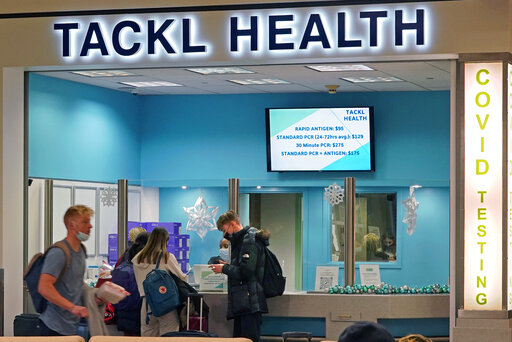 FILE - Travelers wait for COVID testing at Pittsburgh International Airport in Imperial, Pa., on Dec. 27, 2021.  The Biden administration is lifting its requirement that international air travelers to the U.S. take a COVID-19 test within a day before boarding their flights, easing one of the last remaining government mandates meant to contain the spread of the coronavirus.
(AP Photo/Gene J. Puskar, File)