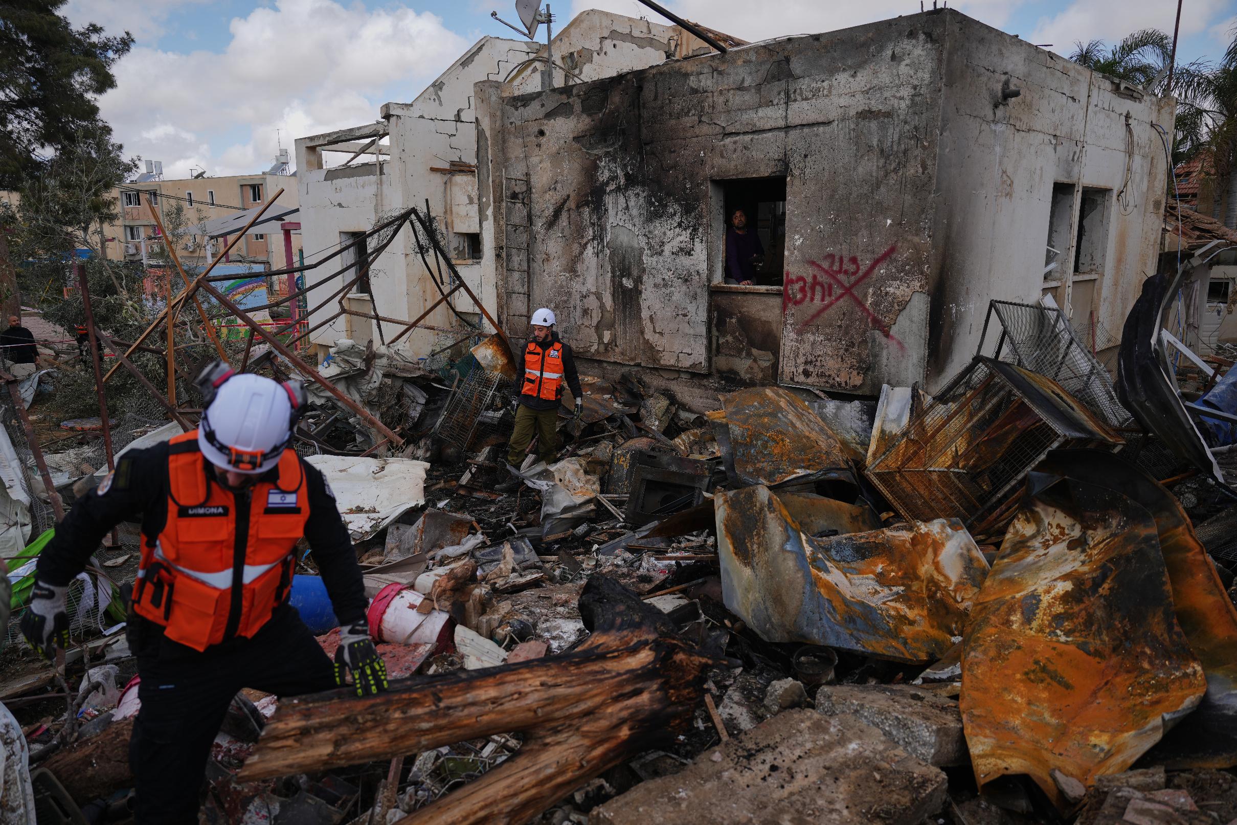 Israeli security forces survey the site that was struck by an Iranian missile in Dimona, southern Israel, Sunday, March 22, 2026. (AP Photo/Ariel Schalit)