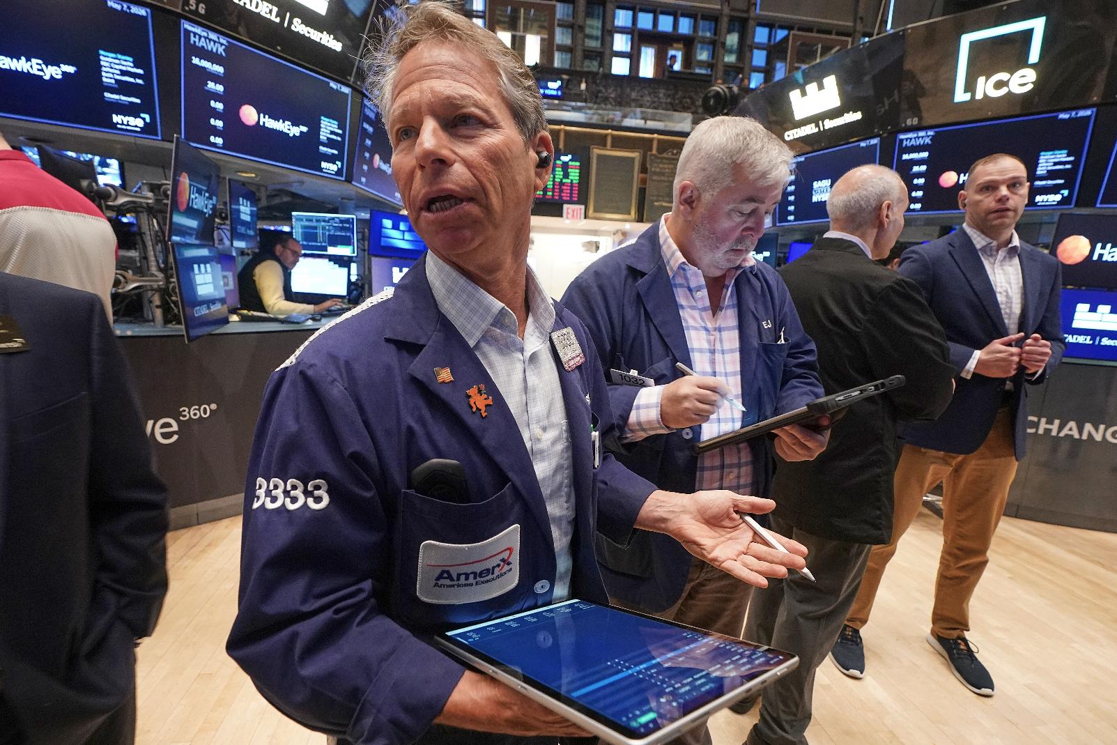 Trader Robert Charmak, left, works on the floor of the New York Stock Exchange, Thursday, May 7, 2026. (AP Photo/Richard Drew)