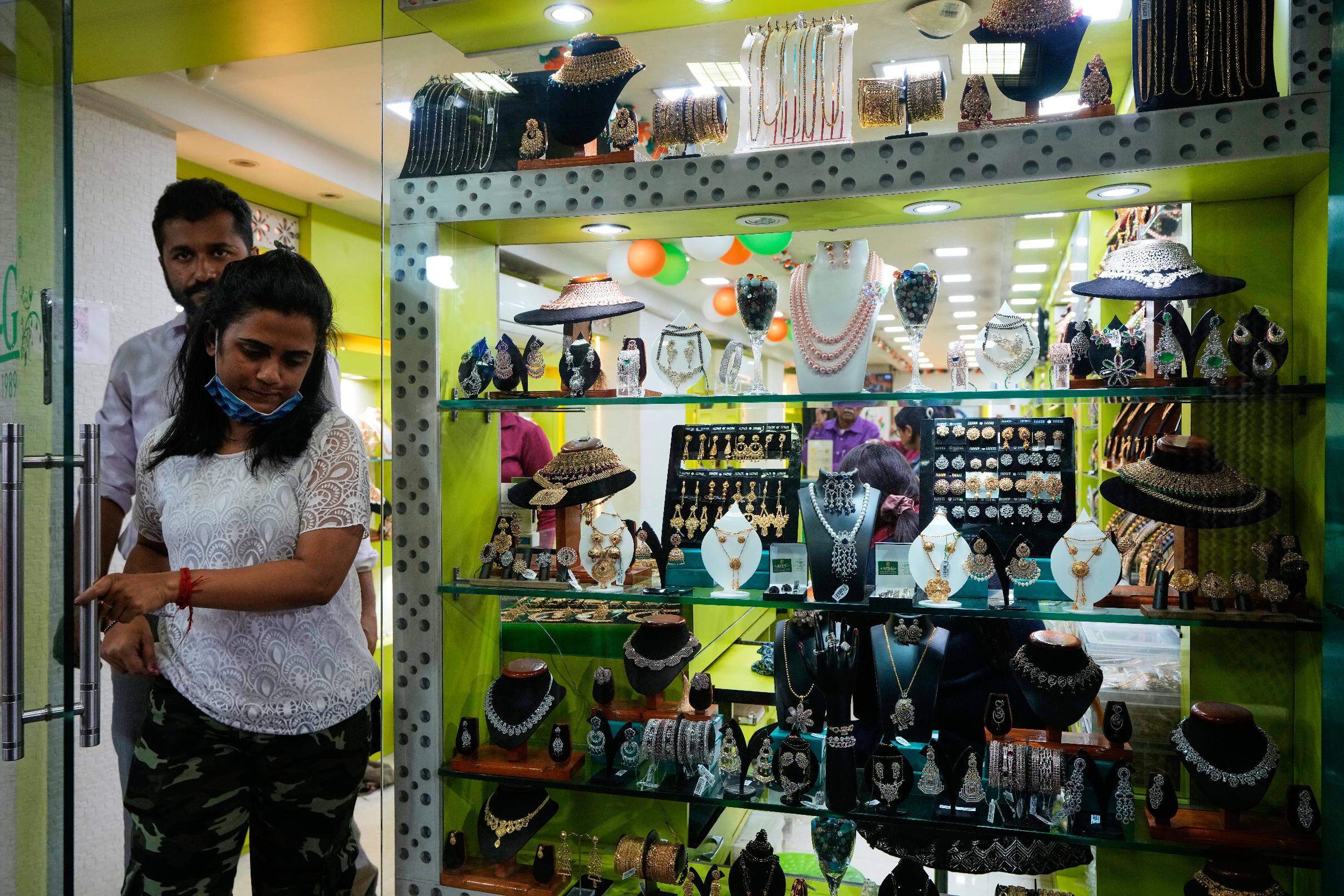 A couple emerge from a jewellery shop in Kolkata, India, Tuesday, Feb. 3, 2026. (AP Photo/Bikas Das)