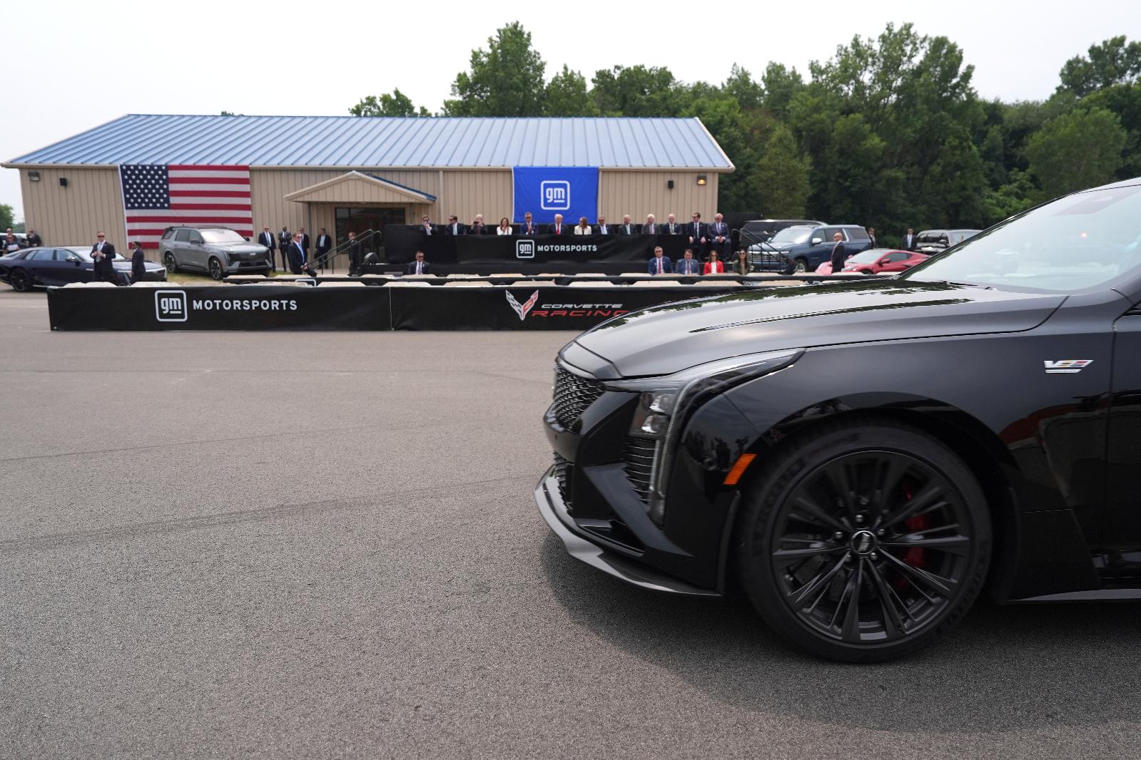 President Donald Trump, seated in background sixth from left, watches a driving demonstration at General Motors proving ground, Monday, July 27, 2026, in Milford, Mich. (AP Photo/Alex Brandon)